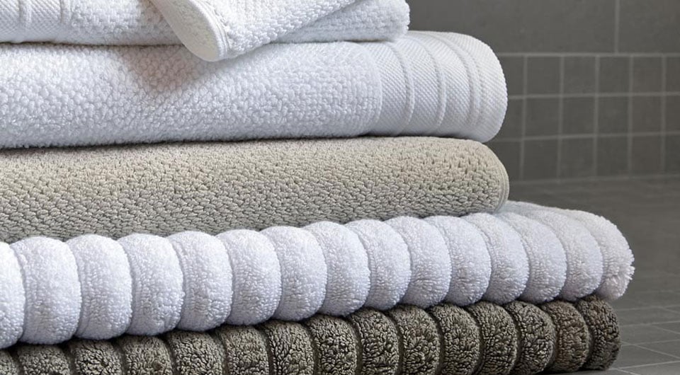 Four white towels stacked together