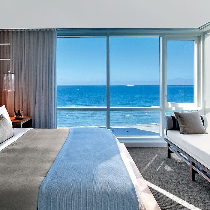 Ocean-view hotel bedroom at 1Hotels South Beach styled with light, breathable bedding designed for relaxed coastal sleep