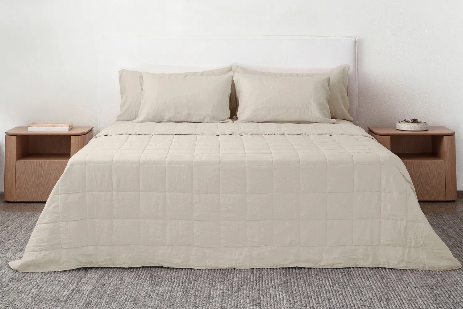 Breathable linen bedding and a light cotton quilt styled for comfortable sleep in warm climates.