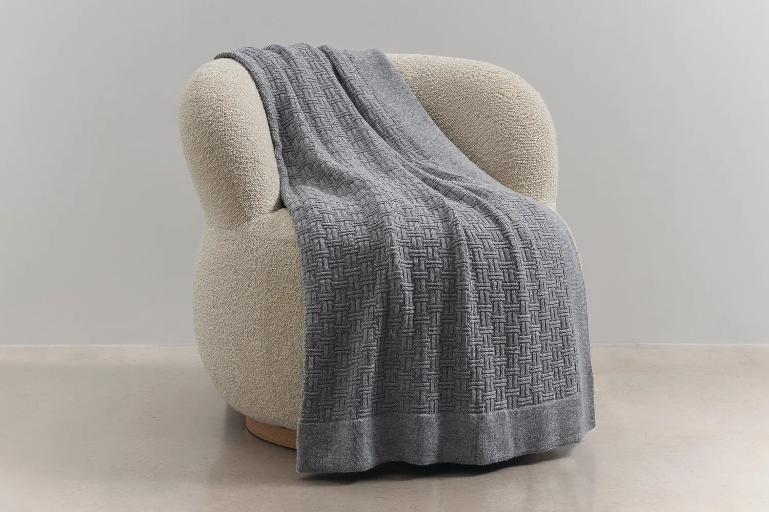 Merino wool throw draped over a sofa showing texture and everyday comfort