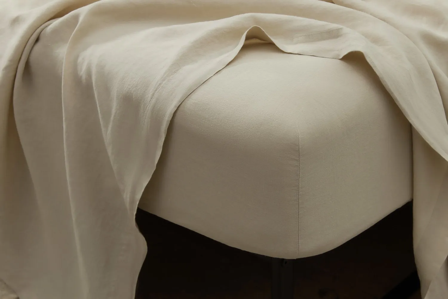 Belgian linen fitted sheet with soft drape, highlighting natural texture and fabric quality.